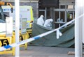 Forensics team at the scene of 58-year-old's death at Elgin Bus Station as floral tributes are paid
