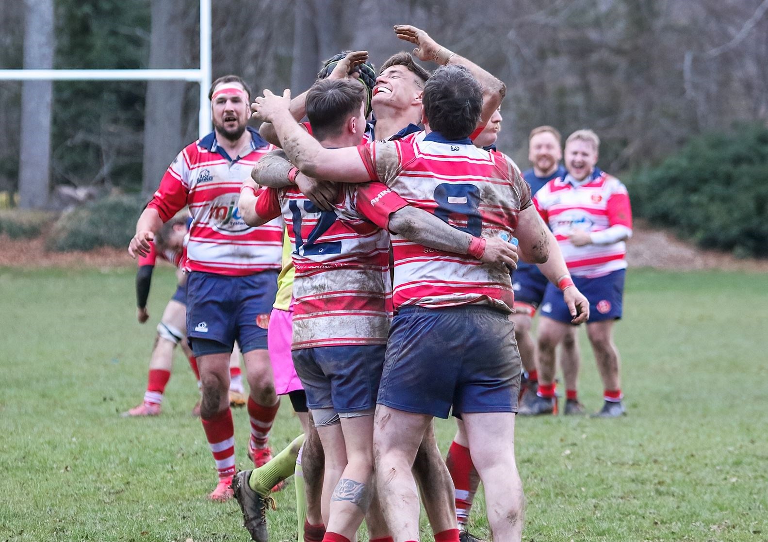 Rory Millar (centre) is mobbed after kicking the winning conversion against Ardrossan. Picture: John MacGregor