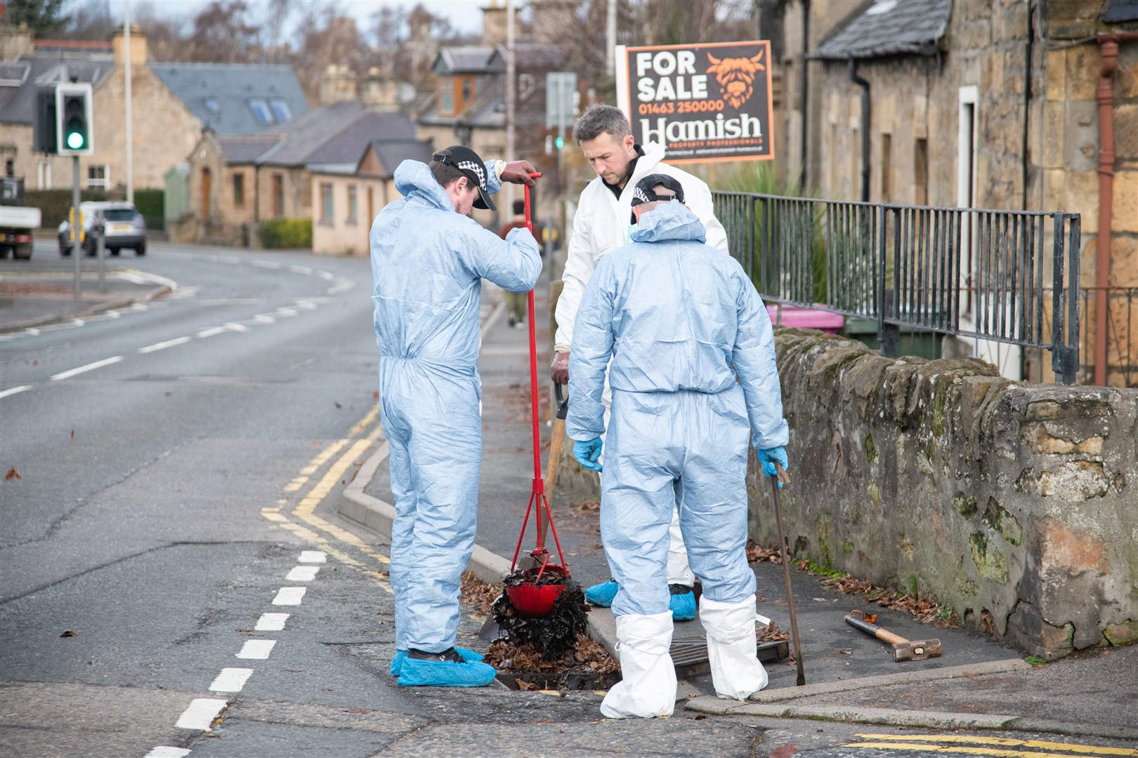 Officers checking drains for evidence last week. Picture: HNMedia