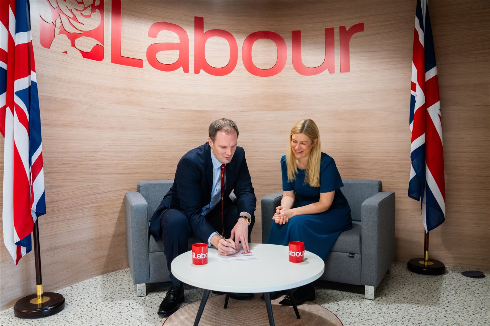 Dan Poulter signing his Labour Party membership form with Ellie Reeves, Labour’s deputy national campaign co-ordinator (Labour Party/PA)