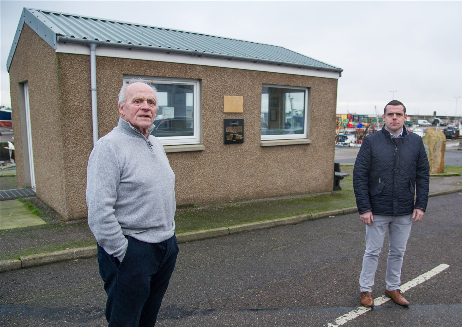Douglas Ross and committee member John Main at Burghead Harbour Shelter where the group responsible the upkeep of the shelter/memorial have been hit with a tax bill from Moray Council. ..Picture: Becky Saunderson..