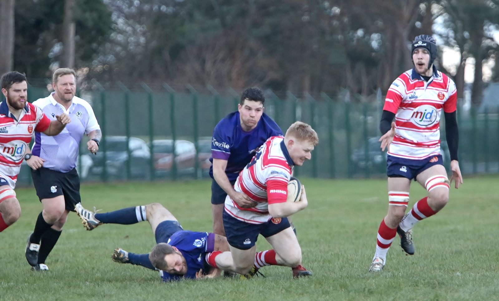Moray's Ewan Simpson being tackled. In the background are Neil Alexander and Cameron Morrison Smith. Picture: John MacGregor