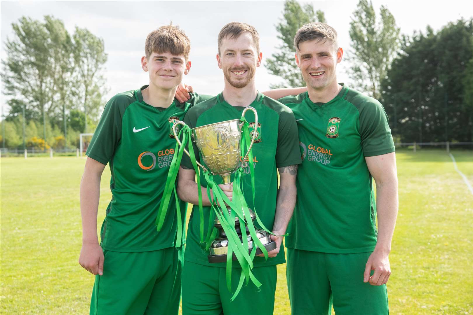 Aiden Cruickshank, Ben Cullen and Finlay Stables with the cup...Dufftown FC (2) vs Forres Thistle FC (2) - Dufftown FC win 5-3 on penalties - Elginshire Cup Final held at Logie Park, Forres 14/05/2022...Picture: Daniel Forsyth..