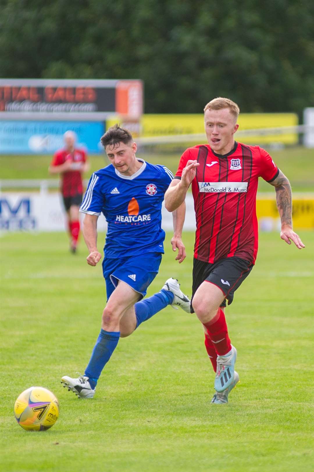 Lossiemouth's Ross Archibald chases Elgin winger Conor O'Keefe. Picture: Daniel Forsyth..