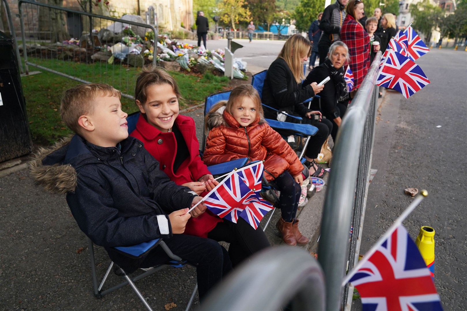 Members of the public in Ballater ahead of the cortege’s arrival (Andrew Milligan/PA)