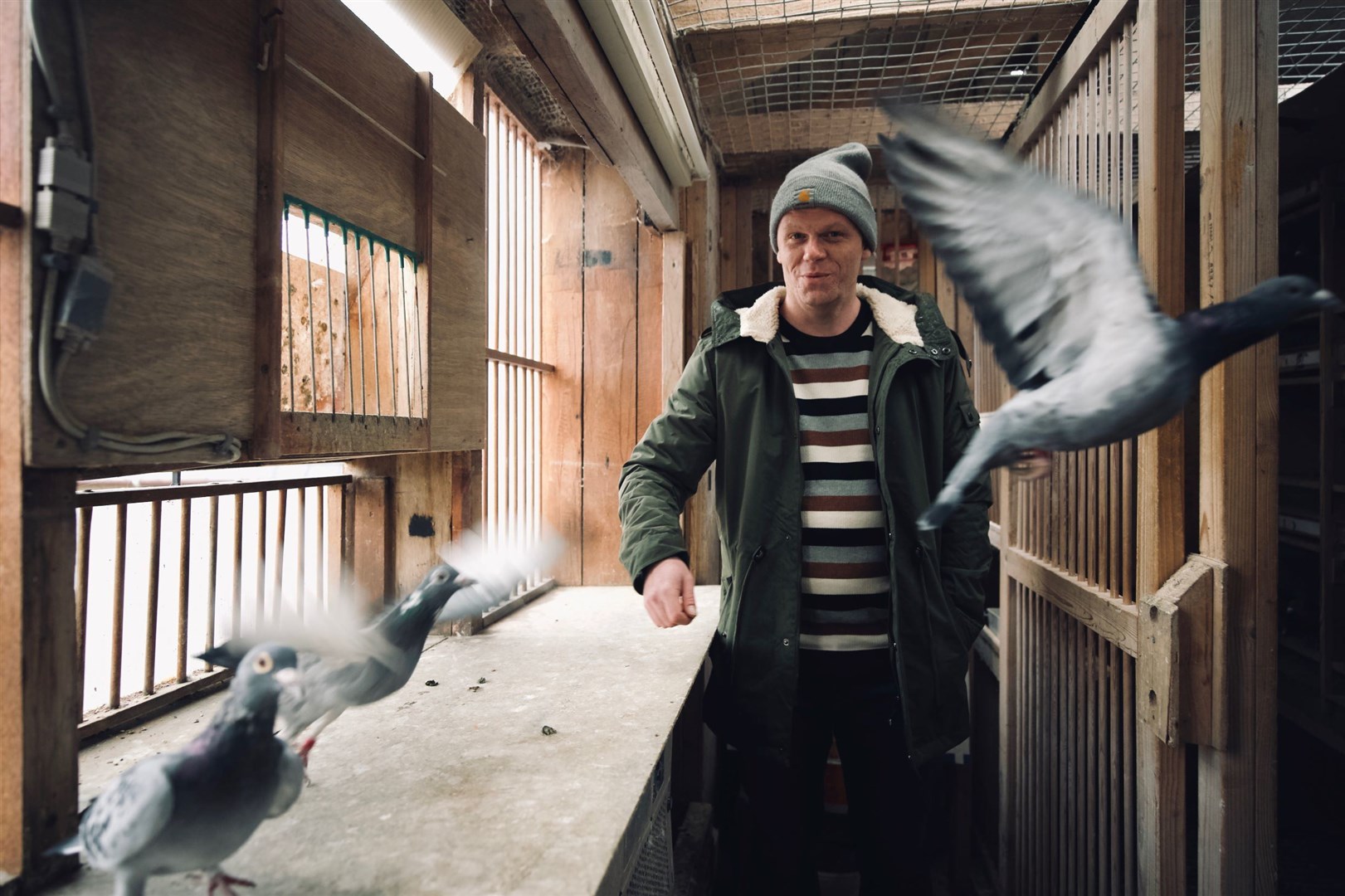 Darren McGarvey in a pigeon loft in Elgin.