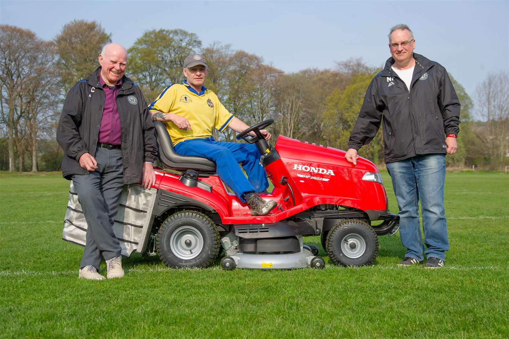 Mike Christie, Geordie Ross and Neil Fotheringham with the new mover Elgin Boy’s Club have bought to cut the grass at Morriston. Picture: Daniel Forsyth