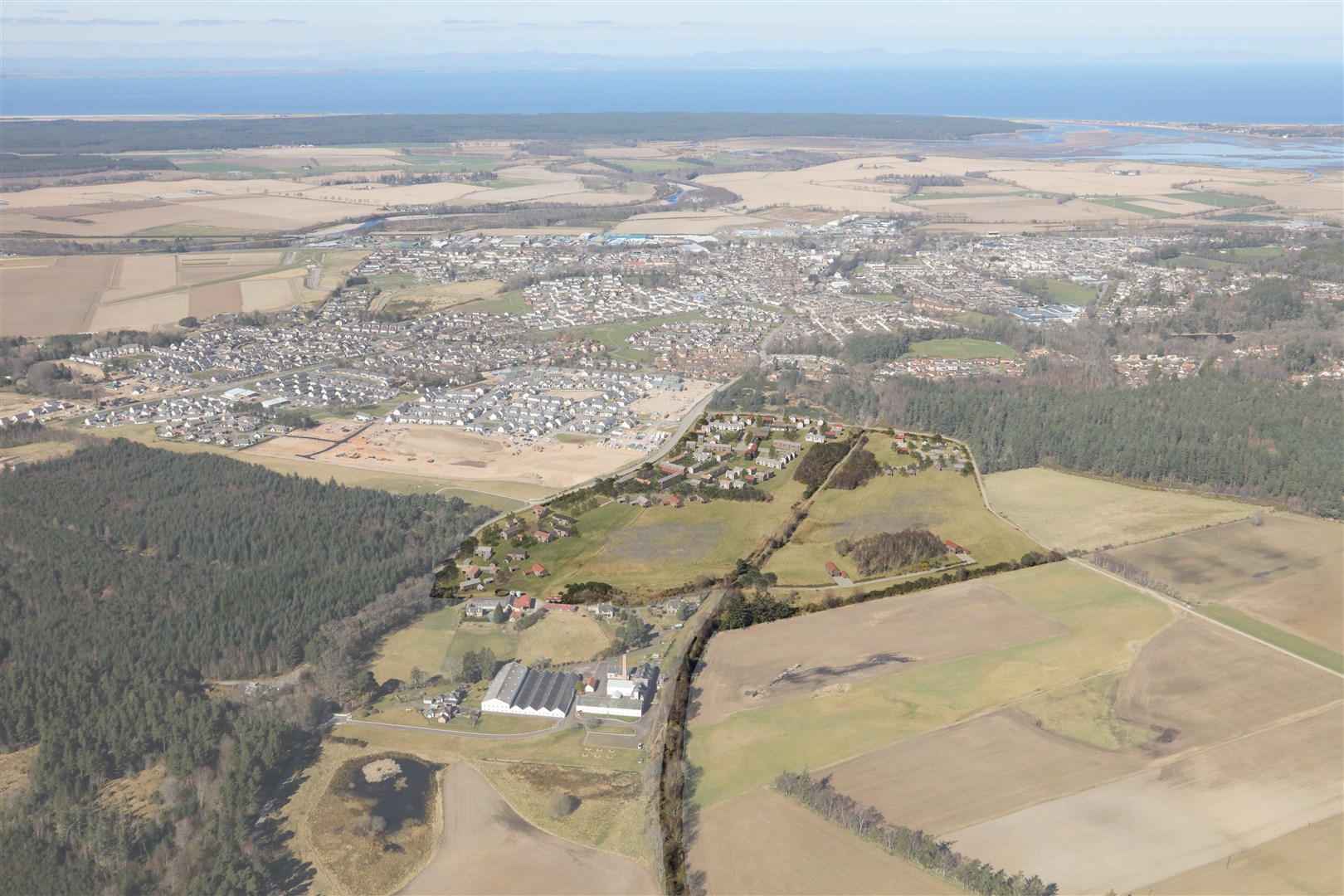 Dallas Dhu with Forres and the Moray Firth in the background. Image courtesy of Fraser/Livingstone Architects.