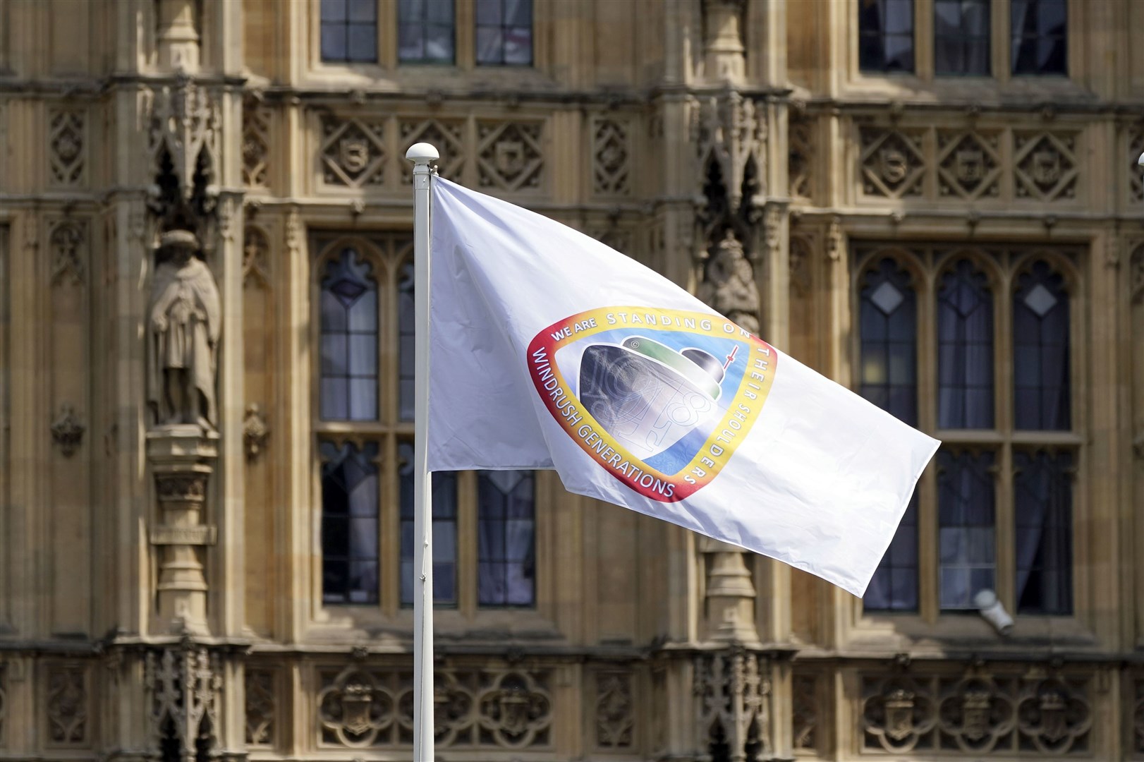 The Windrush flag flies at the Houses of Parliament in London (Aaron Chown/PA)