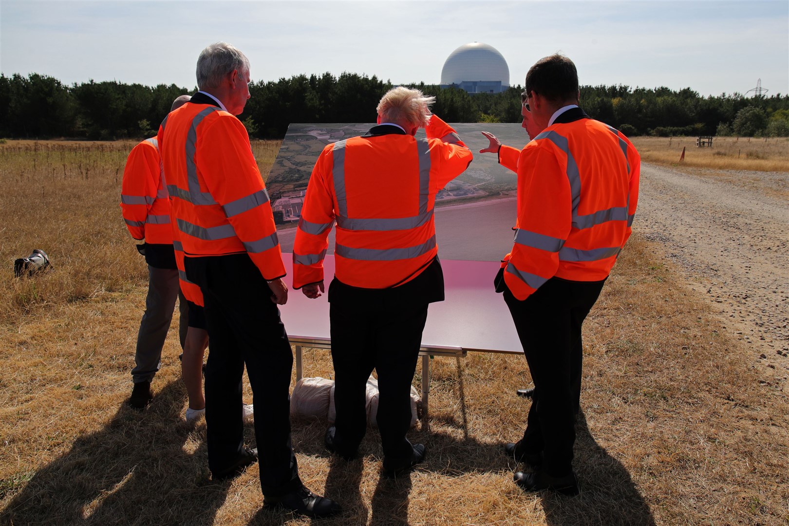 Mr Johnson (centre) looks at plans for the Sizewell C nuclear power station project (Chris Radburn/PA)