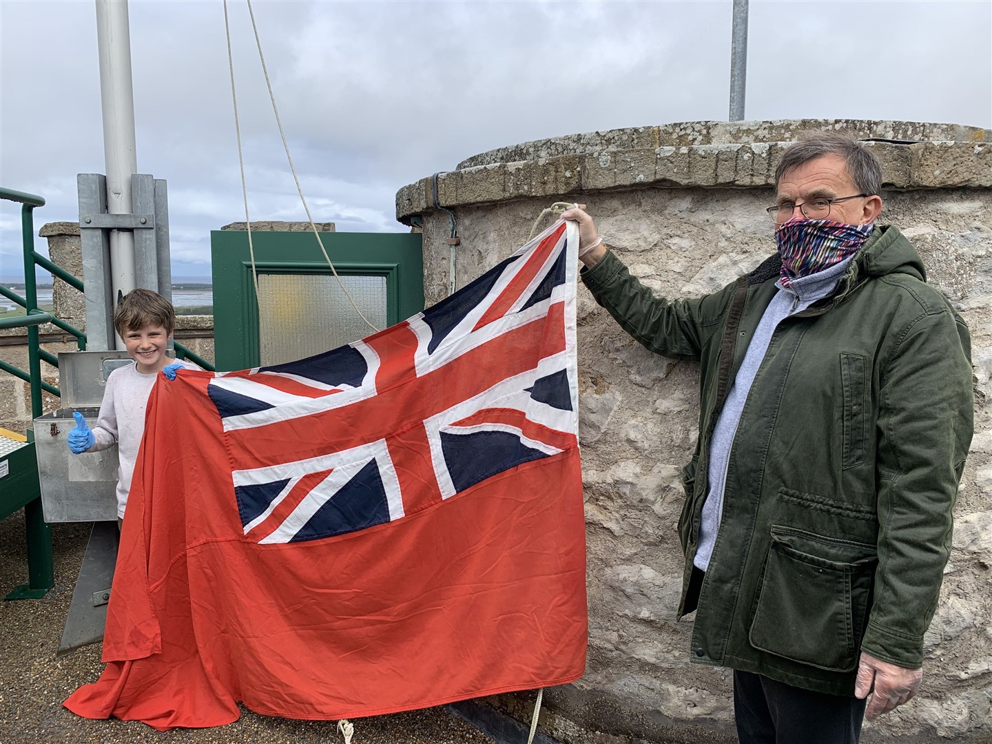 Teddy and Michael raise the Red Ensign above Nelson's Tower to show it's open again to the public.