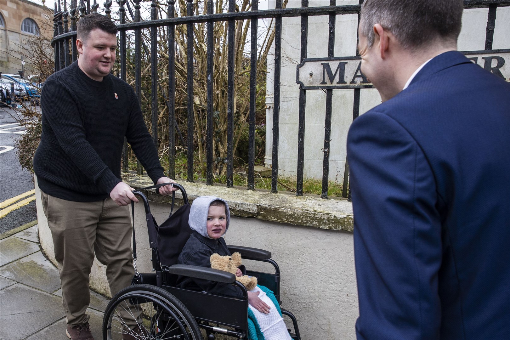 Mairtin MacGabhann and his six-year-old son Daithi MacGabhann meets former Northern Ireland First Minister Paul Givan (right) outside Hillsborough Castle in Northern Ireland (Liam McBurney/PA)
