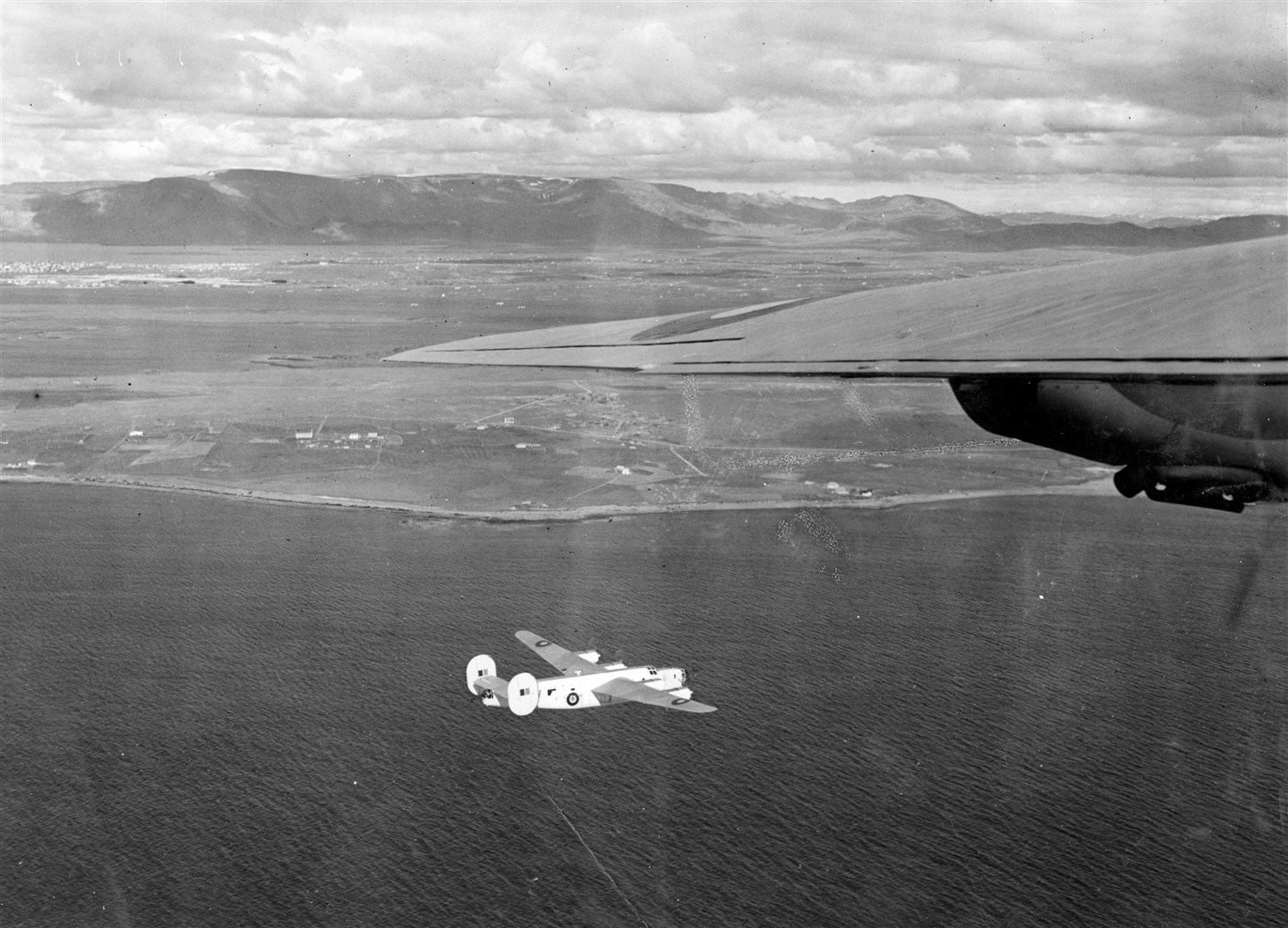 Consolidated Liberator GR.IIIs of 120 Squadron rounding the mountains of Iceland after taking off from Reykjavik to escort an Arctic convoy. Picture: Air Historical Branch