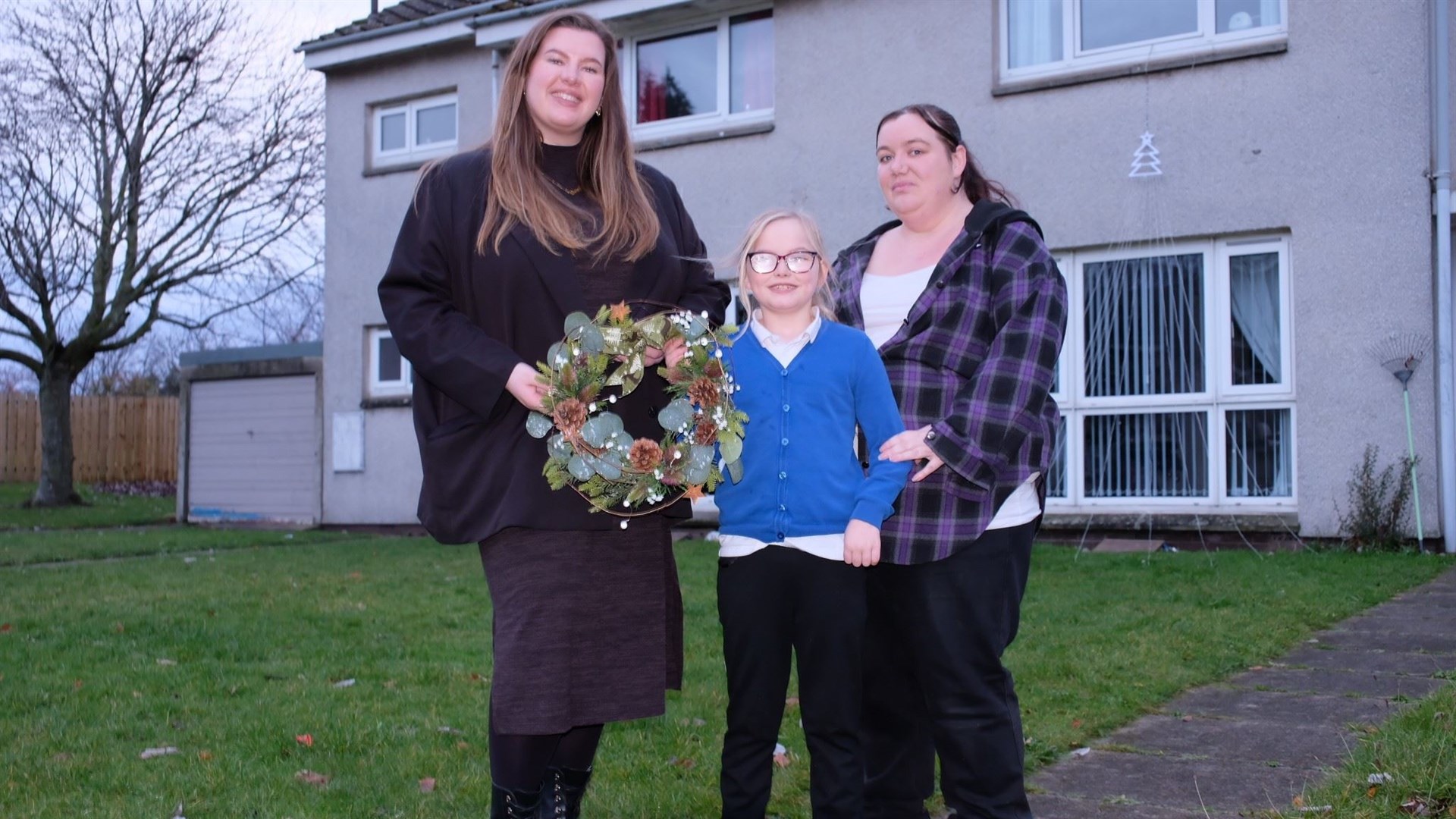 Cllr Amber Dunbar (left) with new Pinegrove residents Karen McLennan and her daughter Teighan-Leigh.