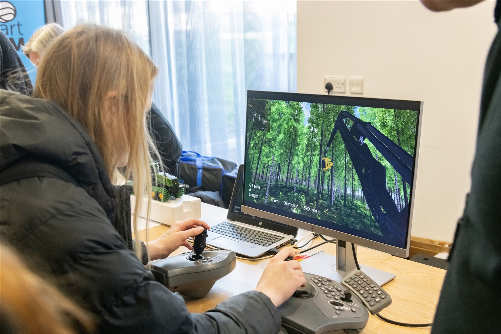 Pupils cut down trees on an interactive machine from Forestry and Land Scotland. Picture: Beth Taylor