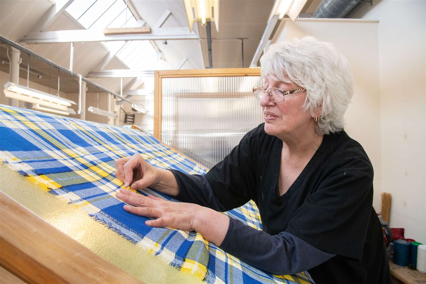 Isobel Ogg, who checks the tartan after production for any issues. Picture: Daniel Forsyth
