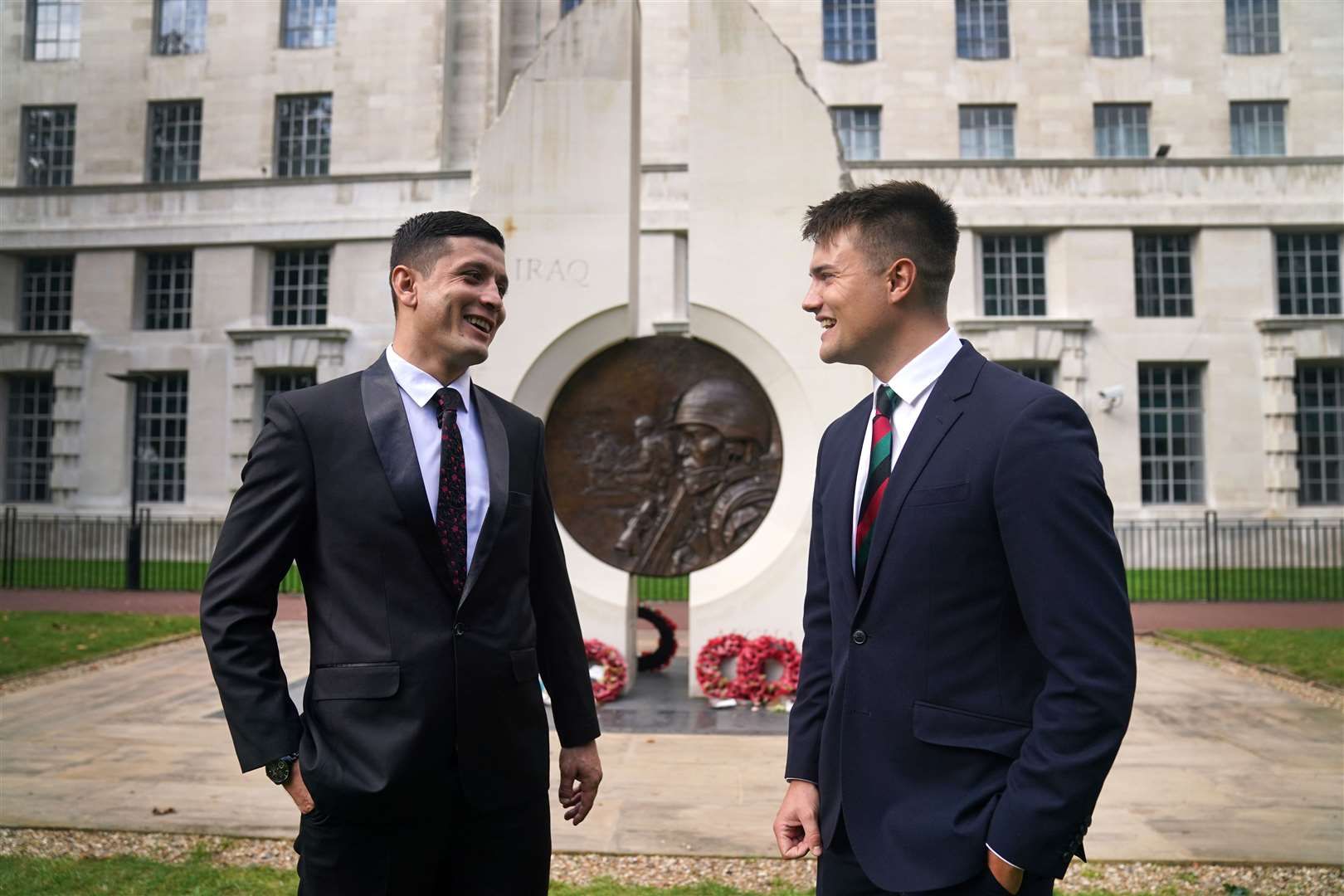First Lieutenant Mohammad Jawad Akbari and Captain Dave Kellett talk to each other by the Iraq Afghanistan Memorial at the Ministry of Defence building in Westminster (Victoria Jones/PA)