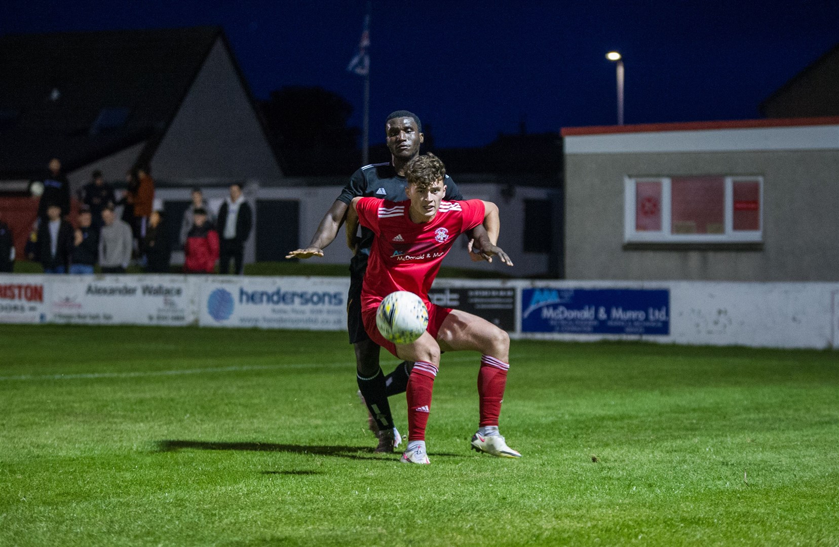 Lossiemouth's Brodie Allen shields the ball from Junior Caulker. Picture: Becky Saunderson..