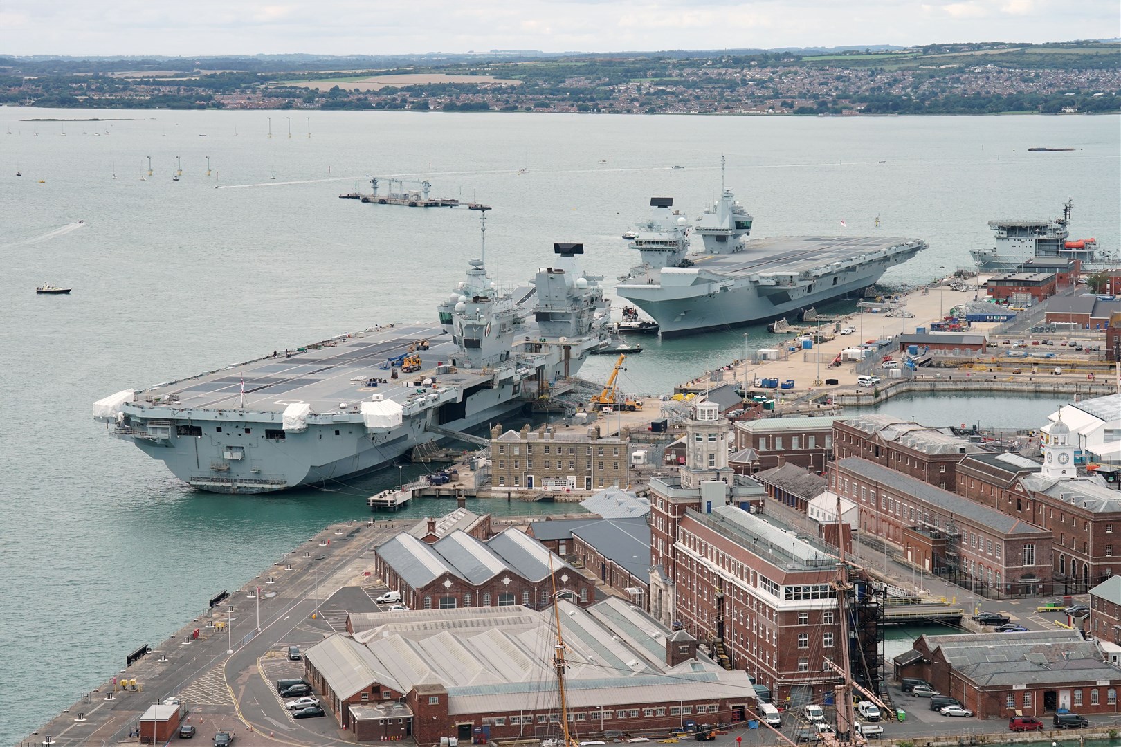 Aircraft carrier HMS Prince of Wales (top right) berths alongside aircraft carrier HMS Queen Elizabeth at Portsmouth Naval Base (Jonathan Brady/PA)