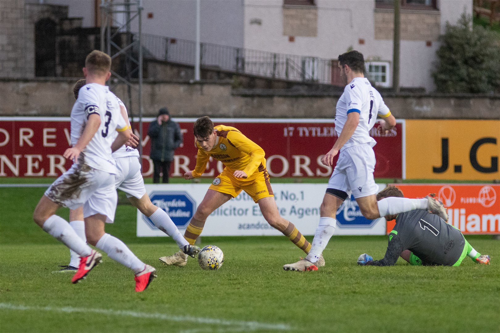 Forres' Ben Barron is unable to get his shot away as he is surrounded by Locos defenders in the first half. ..Forres Mechanics FC (1) vs Inverurie Loco Works FC (1) - Highland Football League 22/23 - Mosset Park, Forres 10/12/2022...Picture: Daniel Forsyth..
