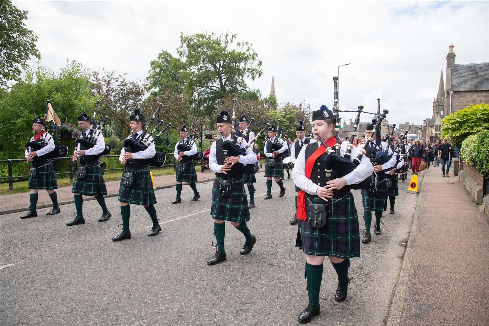 The Forres and District Pipe Band march towards Grant Park ahead of the offical opening of the games...Forres Highland Games 2022...Picture: Daniel Forsyth..