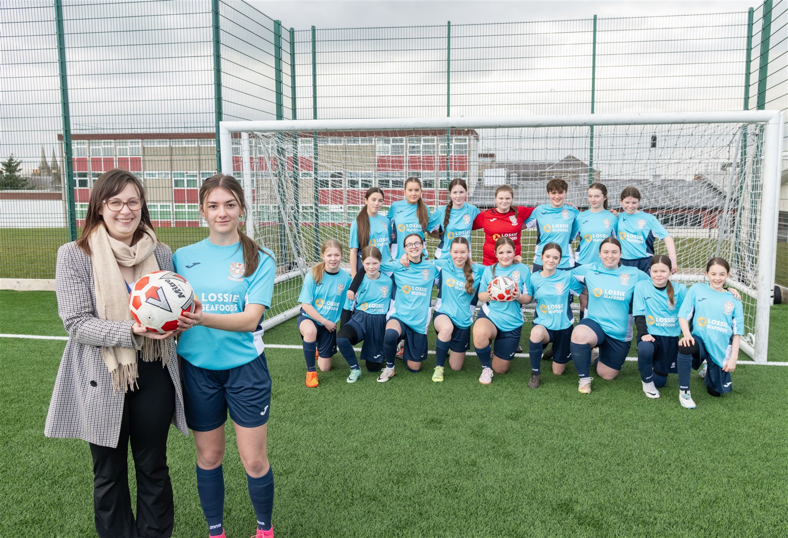 ASL Technical Systems Manager Tammy Rendall congratulated BCHS senior team player Skye Milne and her team-mates on their choice of new strips purchased with a £500 donation from the firm. Picture: Beth Taylor