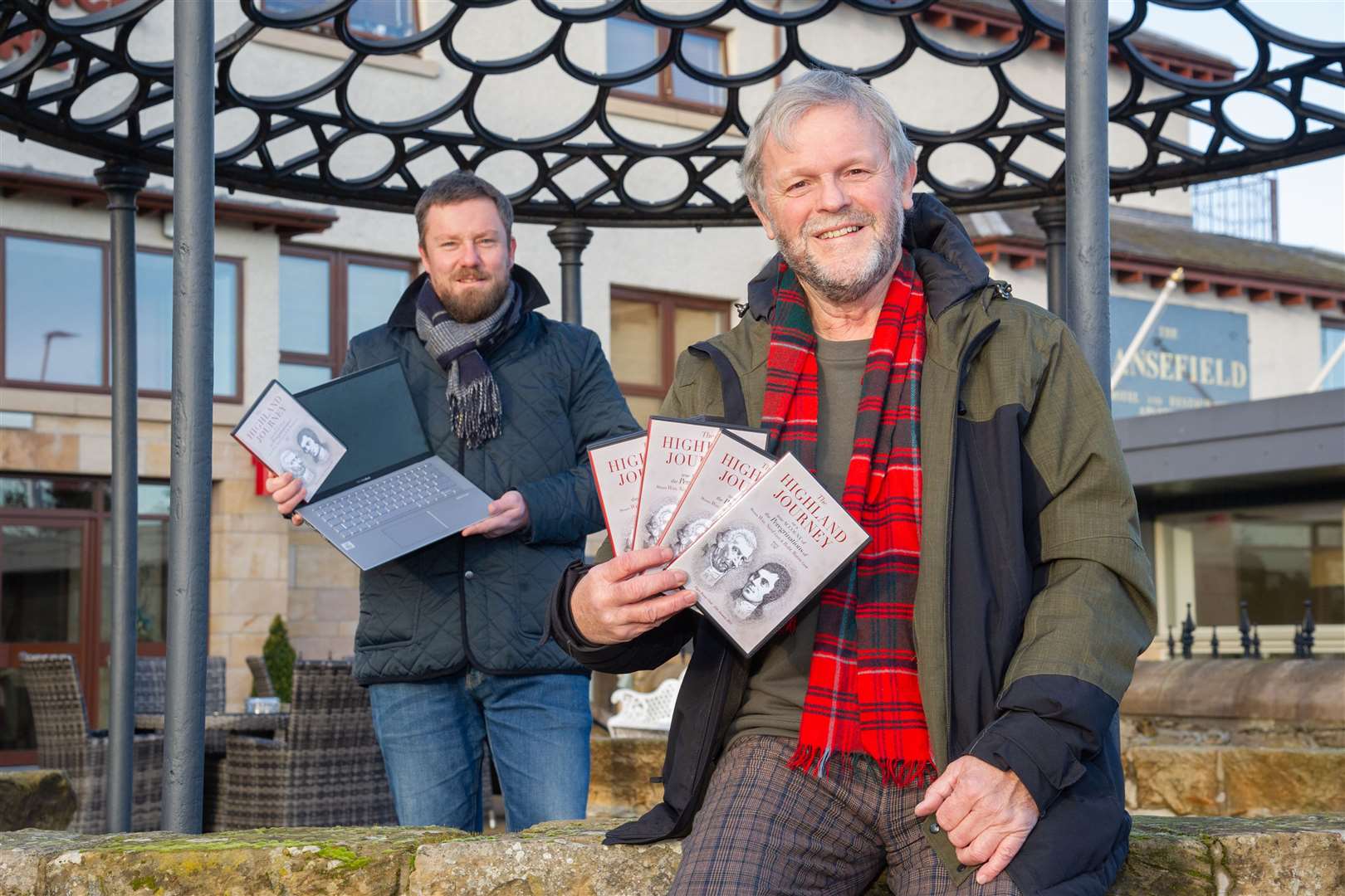 Elgin Burns Club's Neil Urquhart (Secretary) and Donald Lunan (President) with the DVD the club has produced ahead of their virtual Burns Supper on the 25th of January...Picture: Daniel Forsyth..
