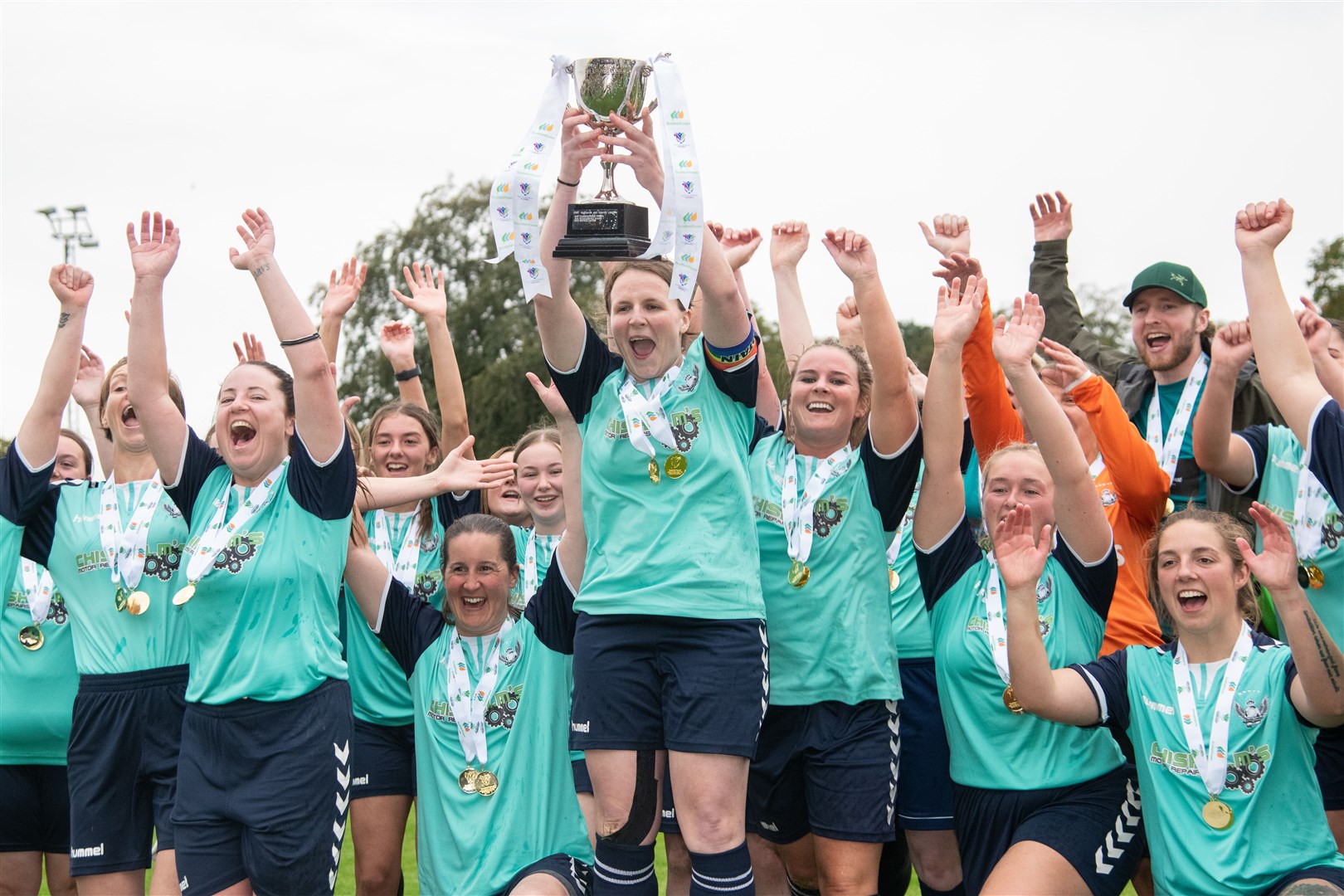 Buckie Ladies hoist the league trophy aloft on their way to an historic double double. Picture: Daniel Forsyth