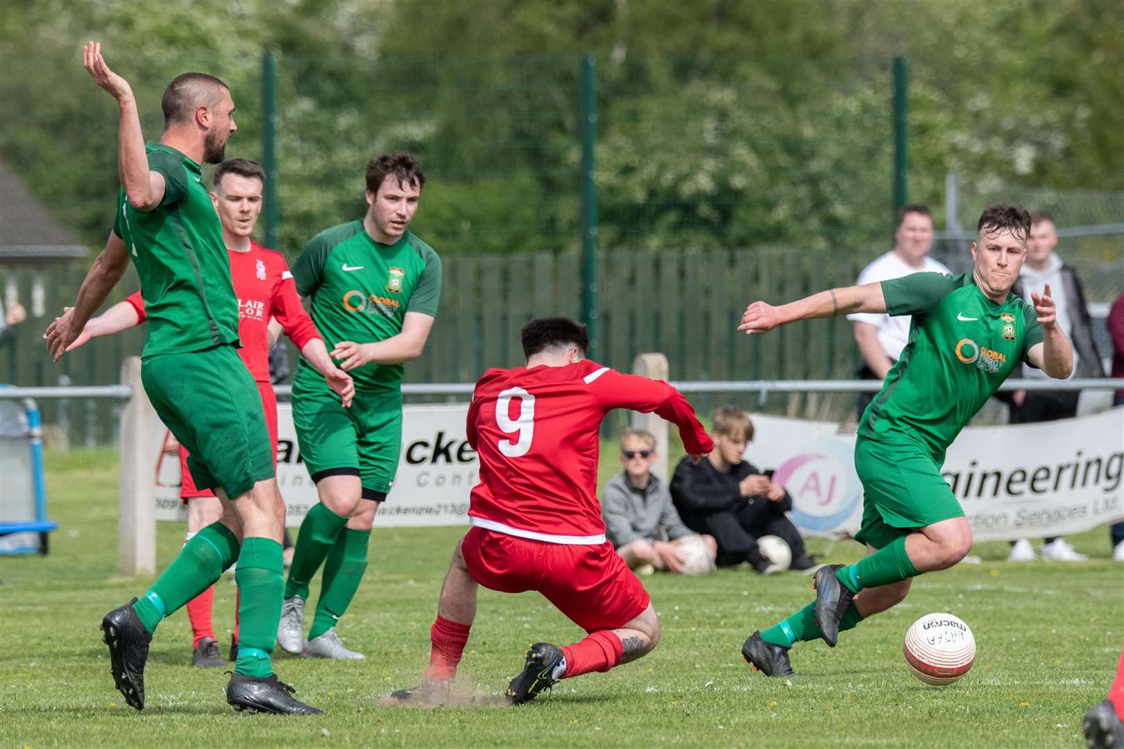 Dufftown's Michael Dunn fouls Forres' Matthew Fraser late in the second half to give away a free kick on the edge of the box...Dufftown FC (2) vs Forres Thistle FC (2) - Dufftown FC win 5-3 on penalties - Elginshire Cup Final held at Logie Park, Forres 14/05/2022...Picture: Daniel Forsyth..