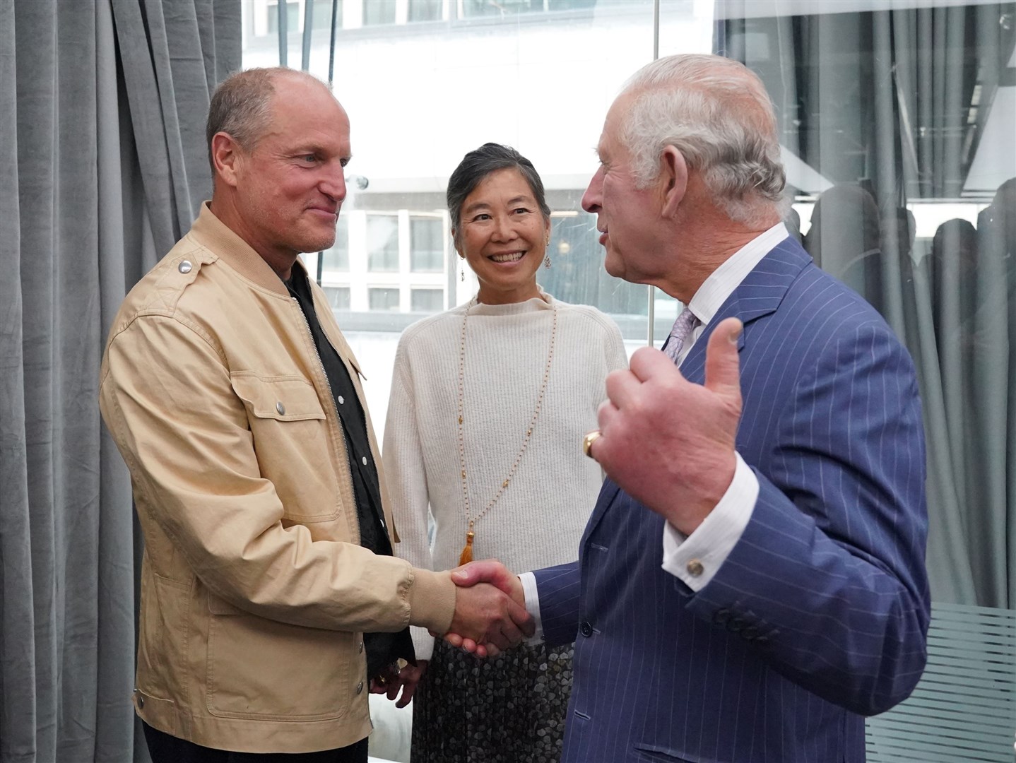 The King with actor Woody Harrelson and his wife Laura Louie (Jonathan Brady/PA)
