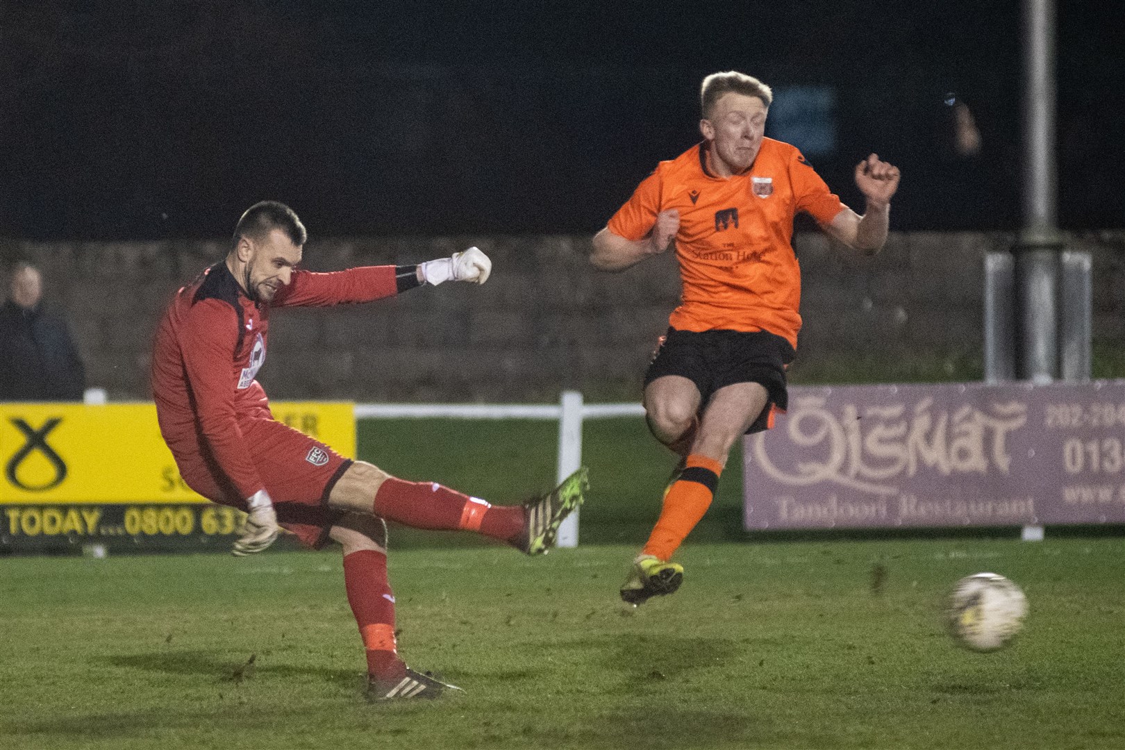 Rothes forward Ross Gunn challenges Joe Barbour as the Fraserburgh keeper clears the ball up the field. Picture: Daniel Forsyth..