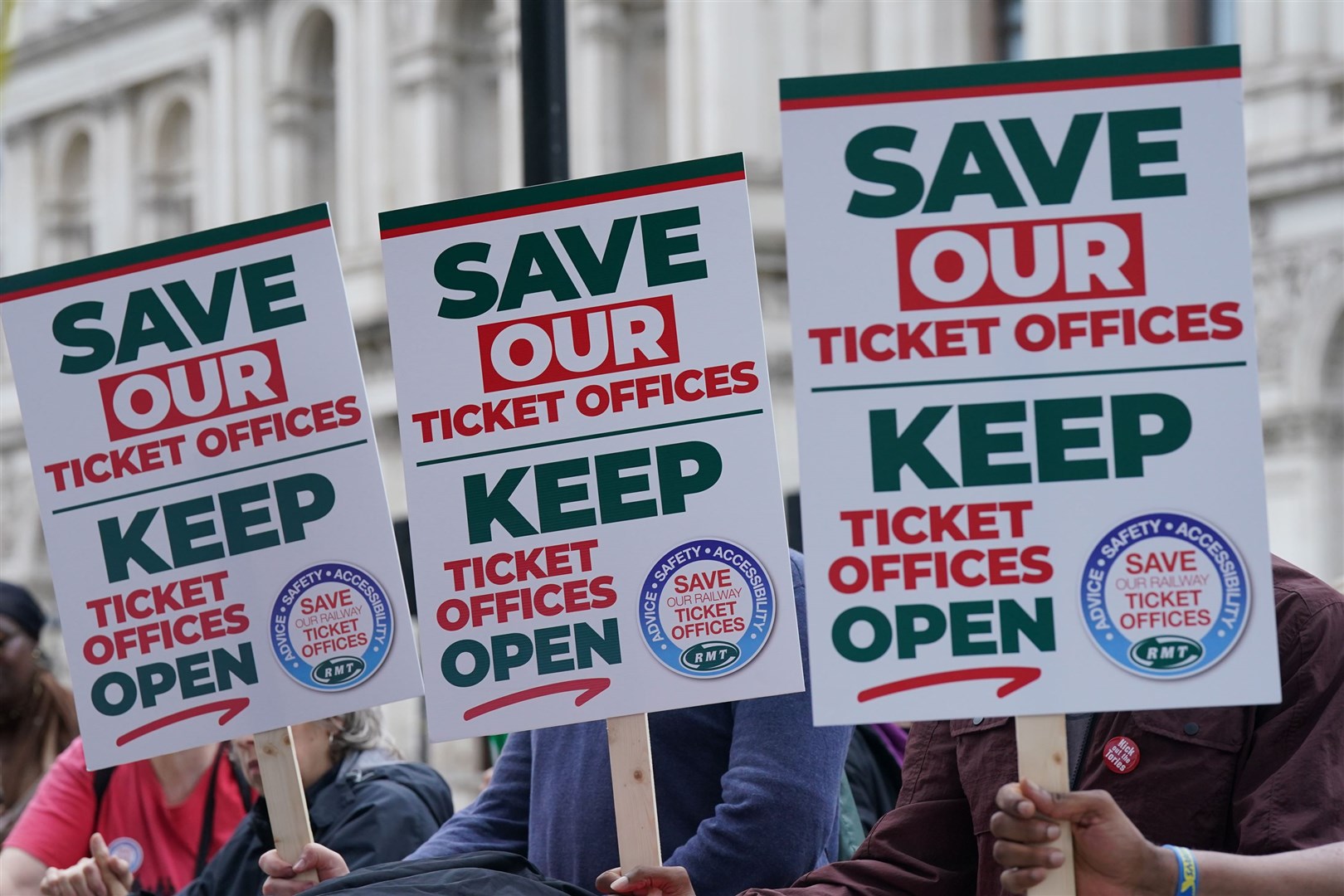People hold placards during a protest organised by the RMT (Lucy North/PA)