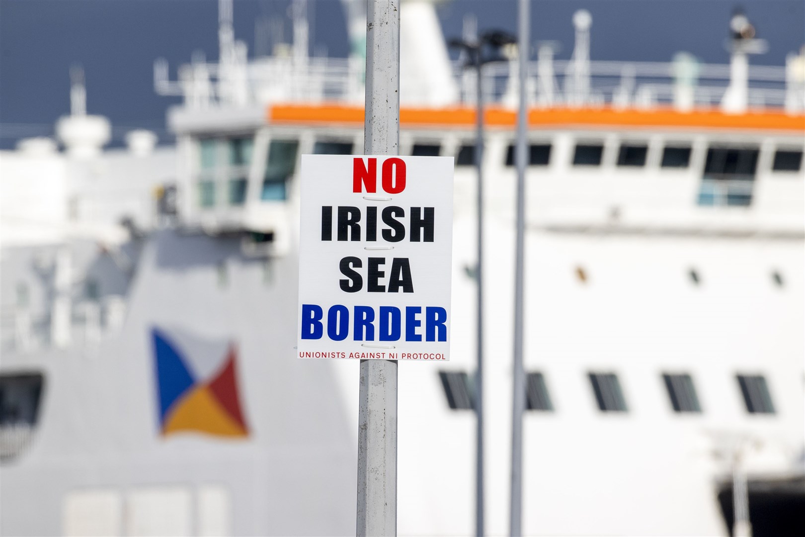 A sign on a lamp post outside Larne Port with the word No Irish Sea Border (Liam McBurney/PA)