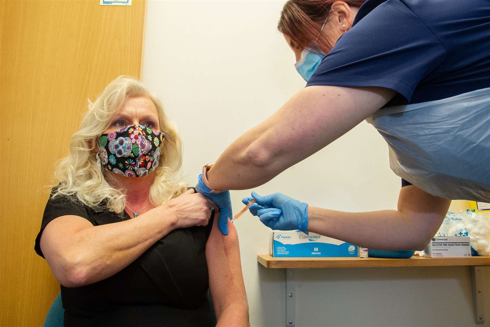 Moray Coast Admin assistant Donna Alcock gets her jab from lead nurse Laura Murgatroyd. Picture: Daniel Forsyth