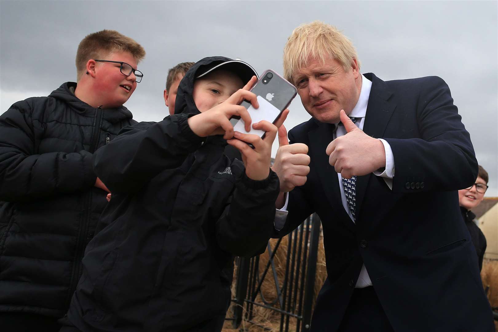 Prime Minister Boris Johnson poses for a selfie as he meets members of the public while campaigning in Hartlepool (PA)
