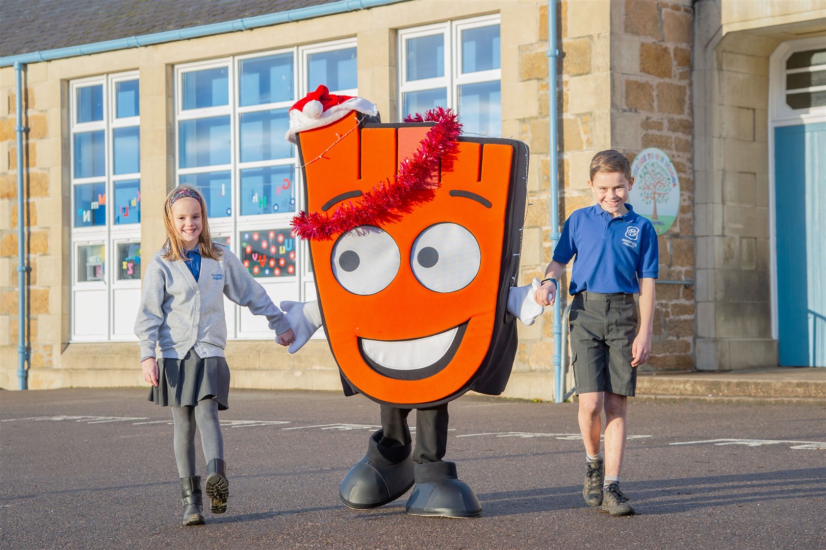 Bishopmill Primary pupils Charlotte Hansen and Cameron Brander take a playground stroll with Living Streets mascot Strider. Picture: Daniel Forsyth.