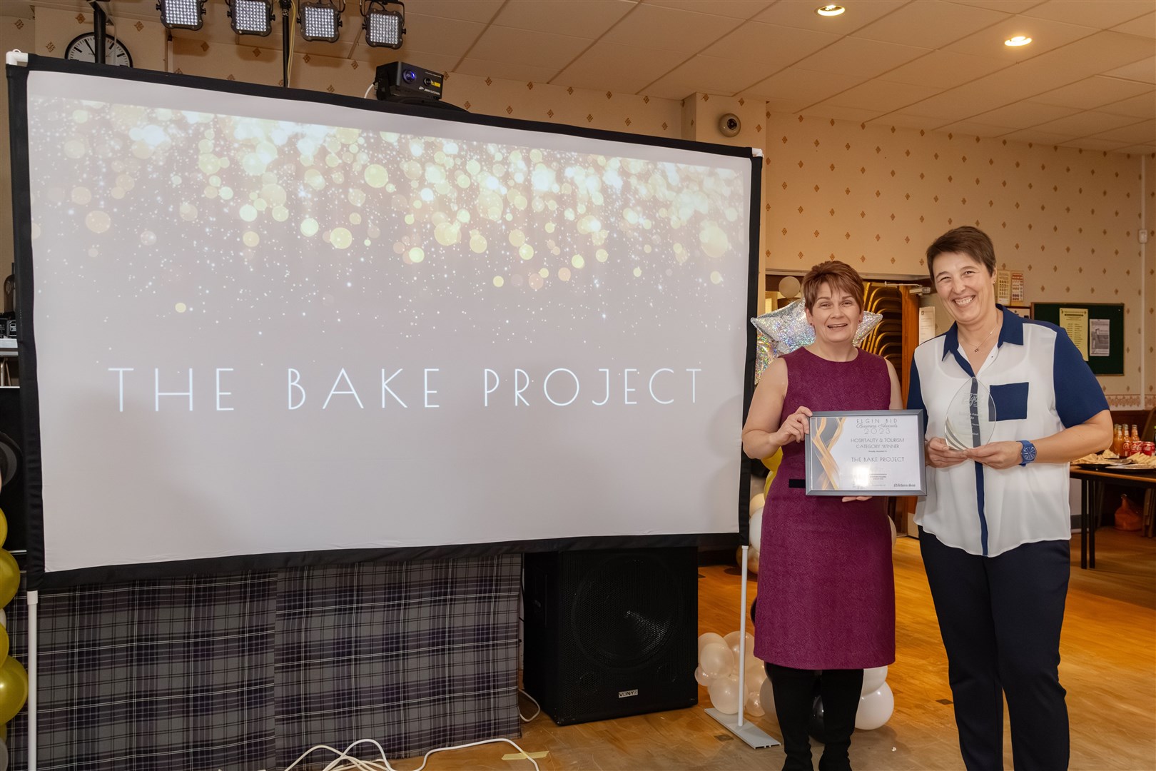 Hazel Robinson (right) of the Bake Project receives her hospitality award from Elgin BID's director Katherine Mackintosh.