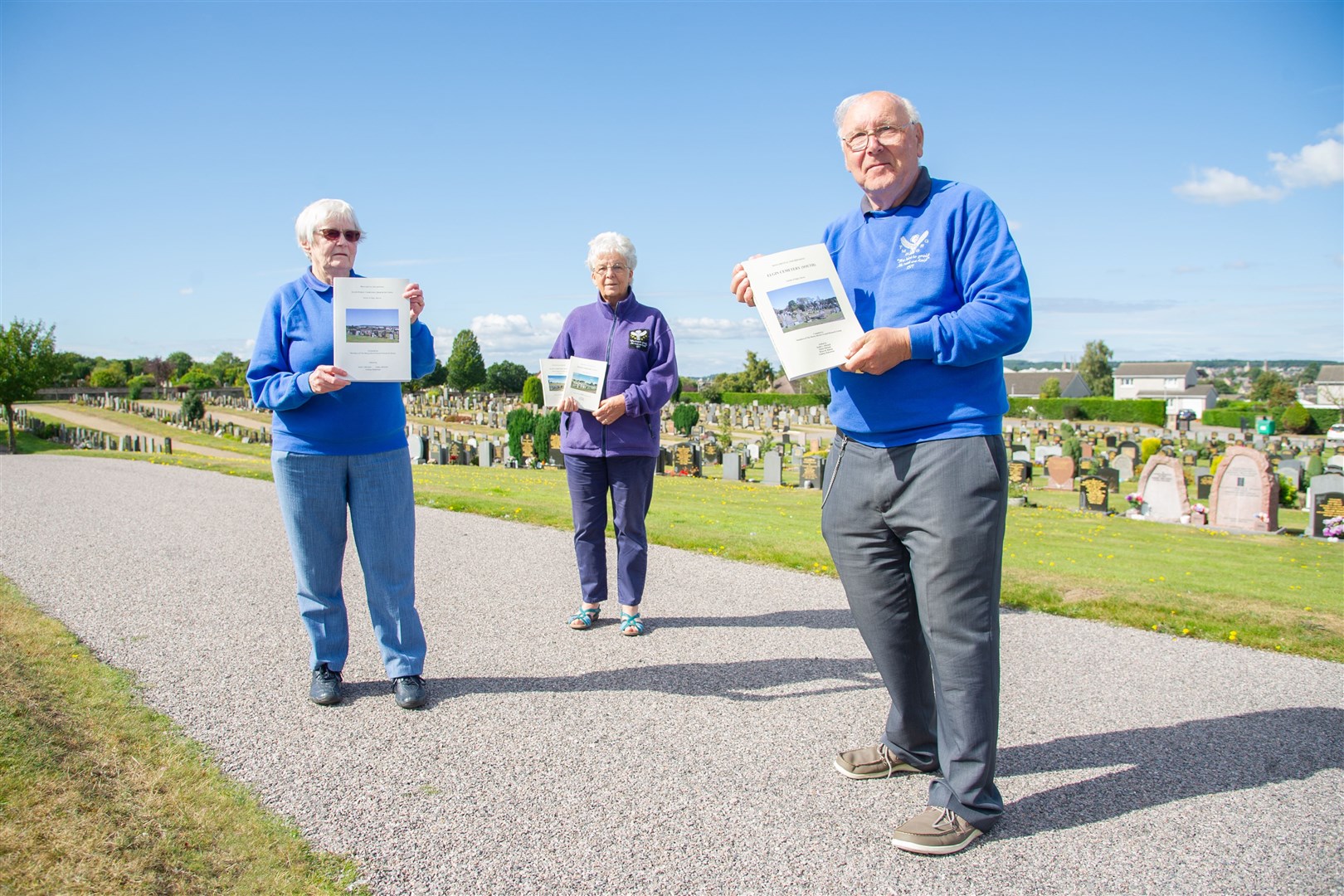 Moray Burial Ground Research group members Helen and Keith Mitchell and Ruth McIntosh (centre) mark the publication of a book on Elgin Public Cemetery after a decade of research work. Picture: Daniel Forsyth.