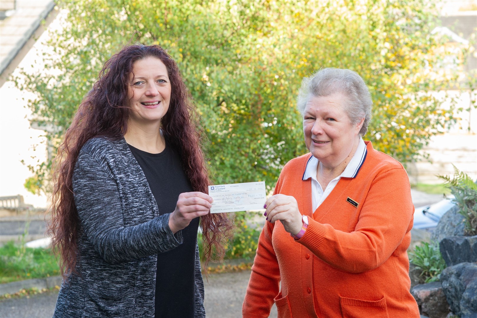 Melanie Johnstone (left) hands over a cheque for £630 to Margaret Lloyd, chair of the League of Friends of Turner Memorial Hospital. Picture: Daniel Forsyth.