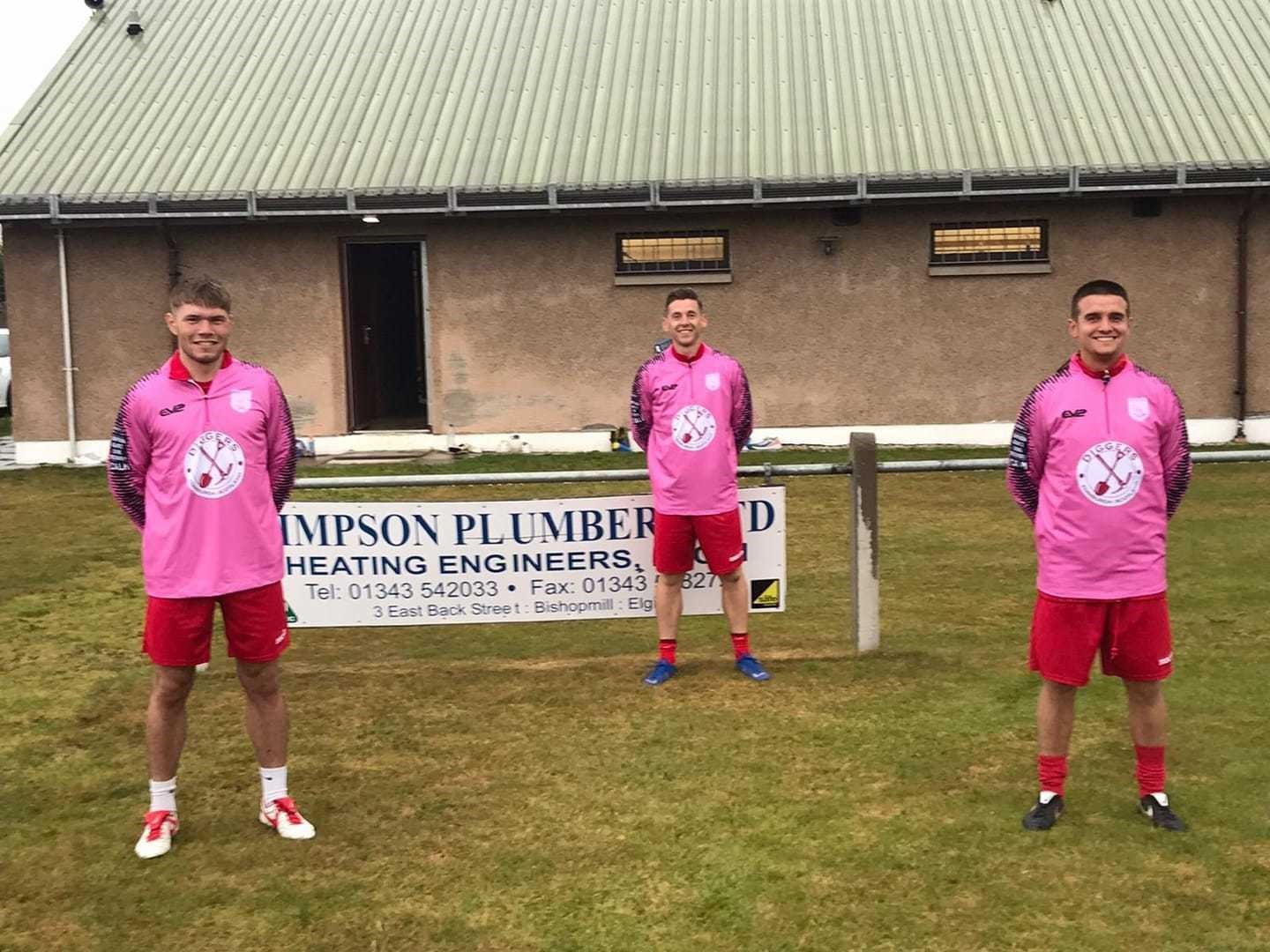 Forres Thistle players receive new training kits from Mental Mechanics after their efforts in a recent hour-long run. Left to right: Ross Paterson, Neil Moir and Danny Black try on their new kits.