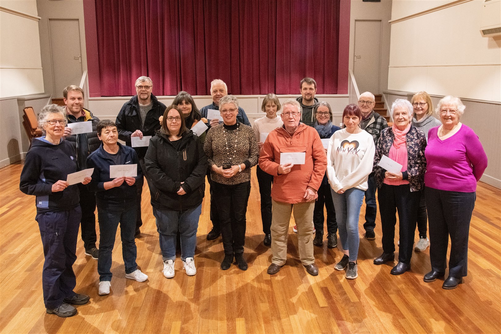 Liz Rennie (centre front) of the Fochabers Village Assocation hands out cheques to local community groups. ..Picture: Daniel Forsyth..