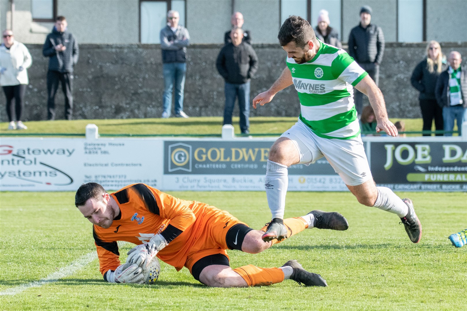 Strathspey keeper Robert Donaldson saves this effort from Buckie's Andy MacAskill. Picture: Daniel Forsyth..