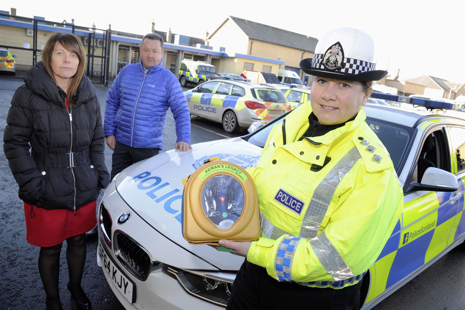 Sandra and Gordon McKandie and Chief Inspector Louise Blakelock with one of the defibrillators provided in road policing vehicles. Picture: Daniel Forsyth.