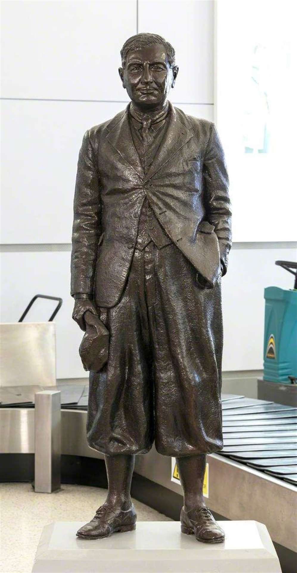 A statue of Ted Fresson stands in the arrivals section of Inverness Airport.