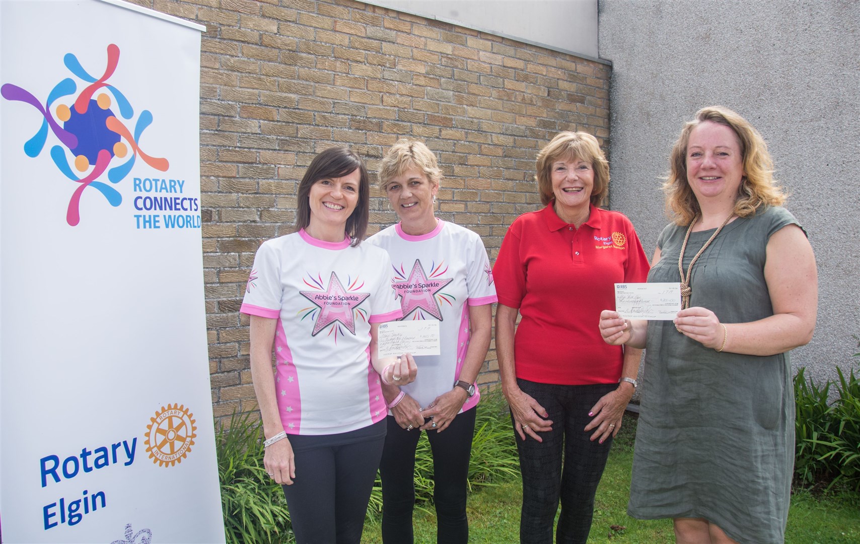 Rotary Elgin president Margaret Stenton presents cheques to (from left) Tammy Main and Kate McGarey of Abbie's Sparkle Foundation and Penny Hamilton (right) of Elgin Youth Cafe. Picture: Becky Saunderson. Image No.044416.