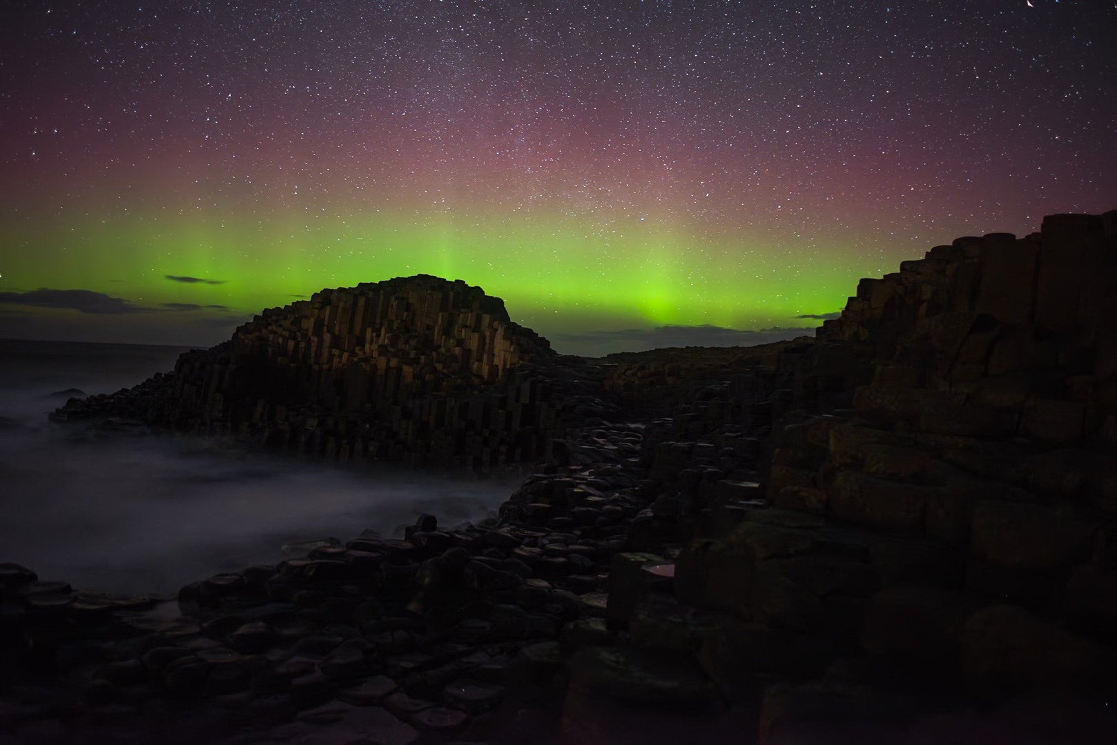 The Northern Lights over the Giant’s Causeway in Northern Ireland (John O’Neill/PA)