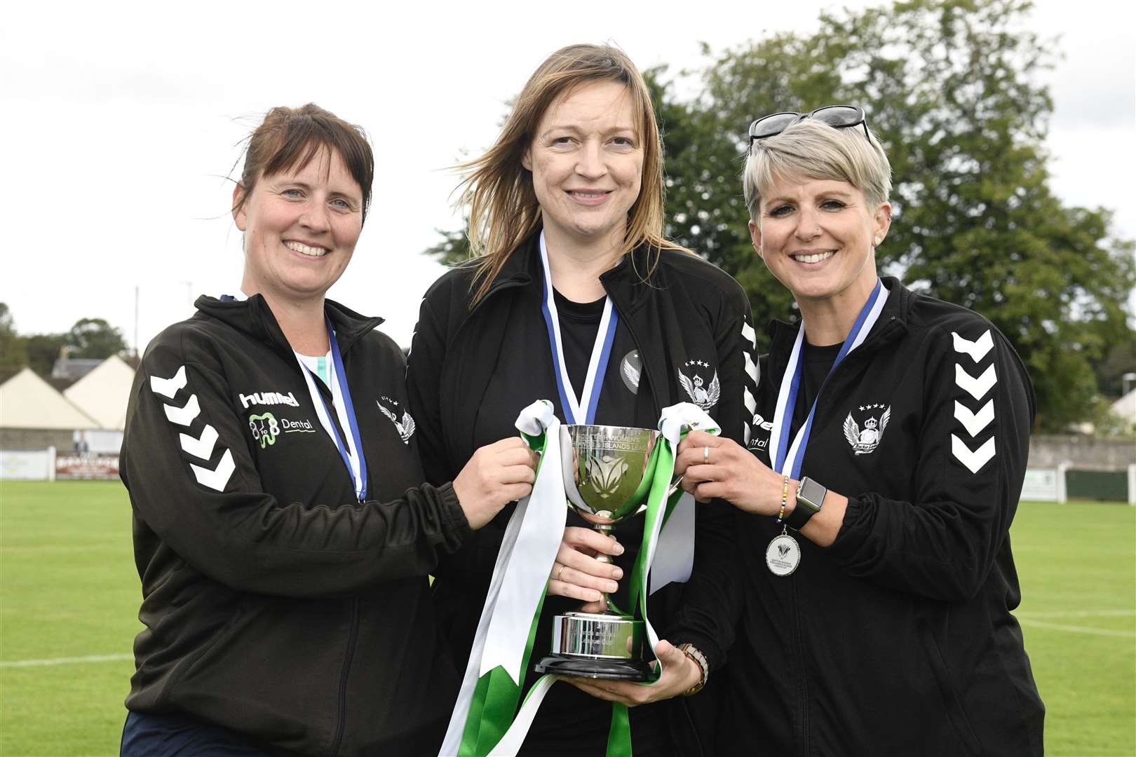 Buckie manager Melissa Smith with her coaching team lift the Highlands and Islands League Cup.