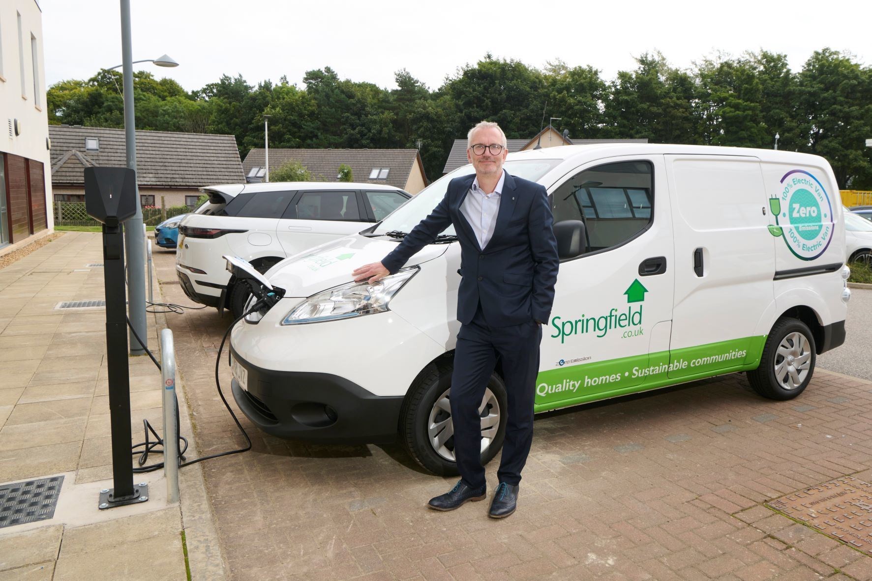 Innes Smith alongside the electric van at the company's Elgin offices.