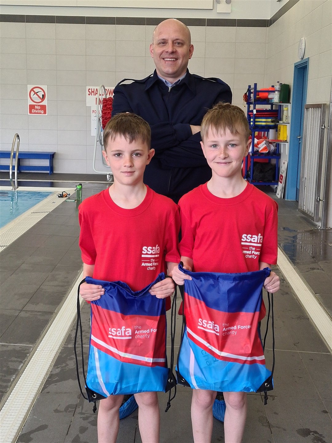 Archie and George Melville received a goodie bag each from Mike Barrett, the chairman of the RAF Lossiemouth In-Service Committee.