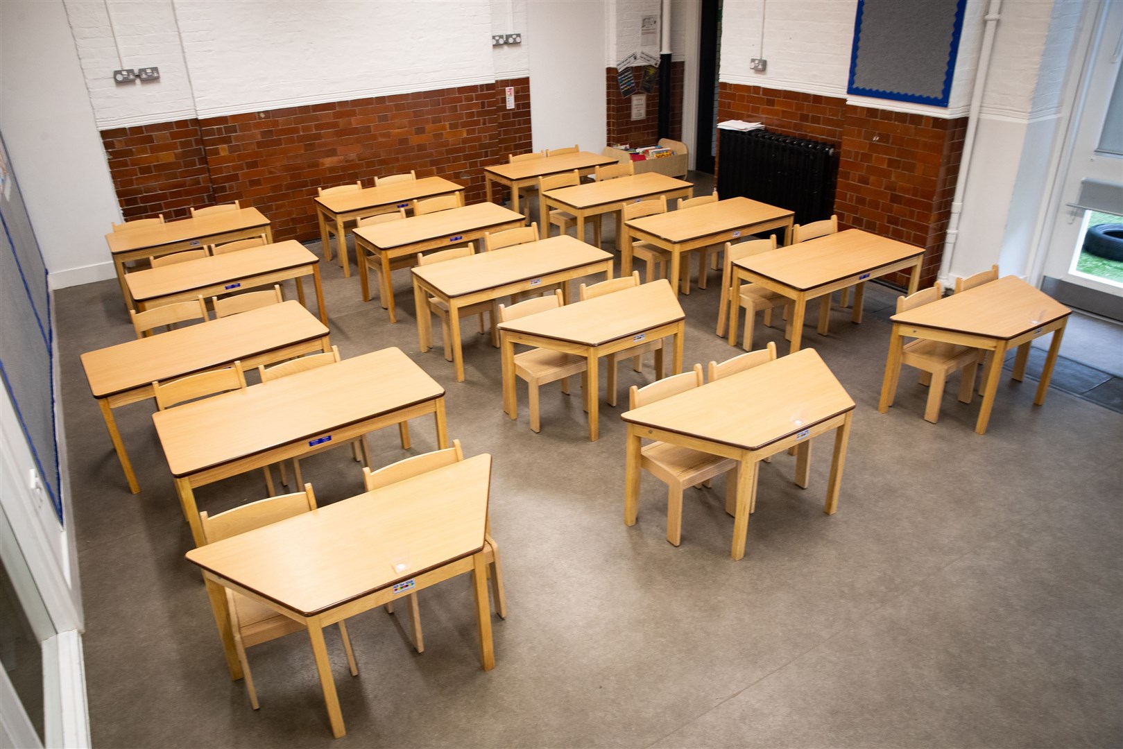 Tables and chairs spaced out for social distancing at the Charles Dickens Primary School in London (Aaron Chown/PA)